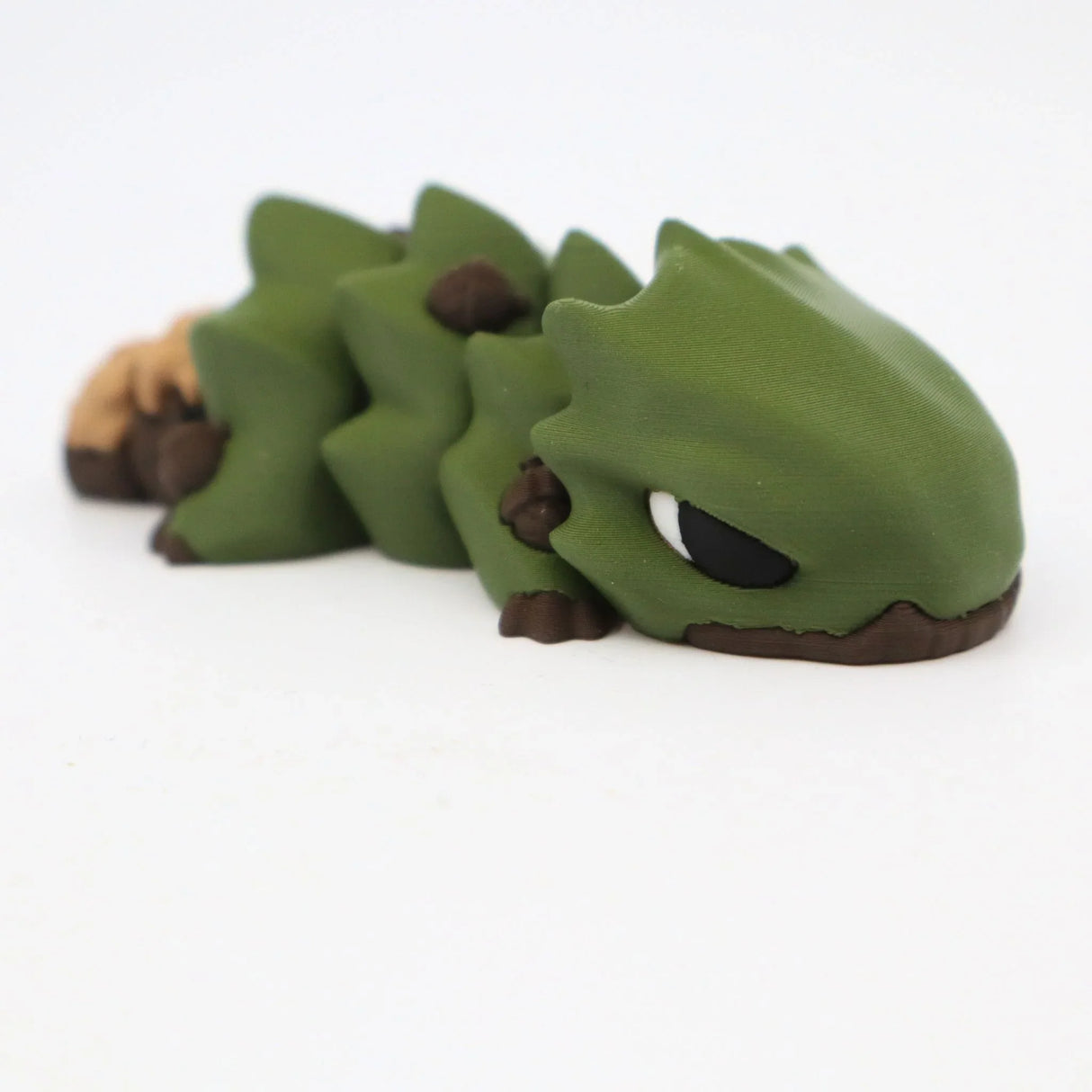 3D printed green sensory toy lizard with brown accents on white background