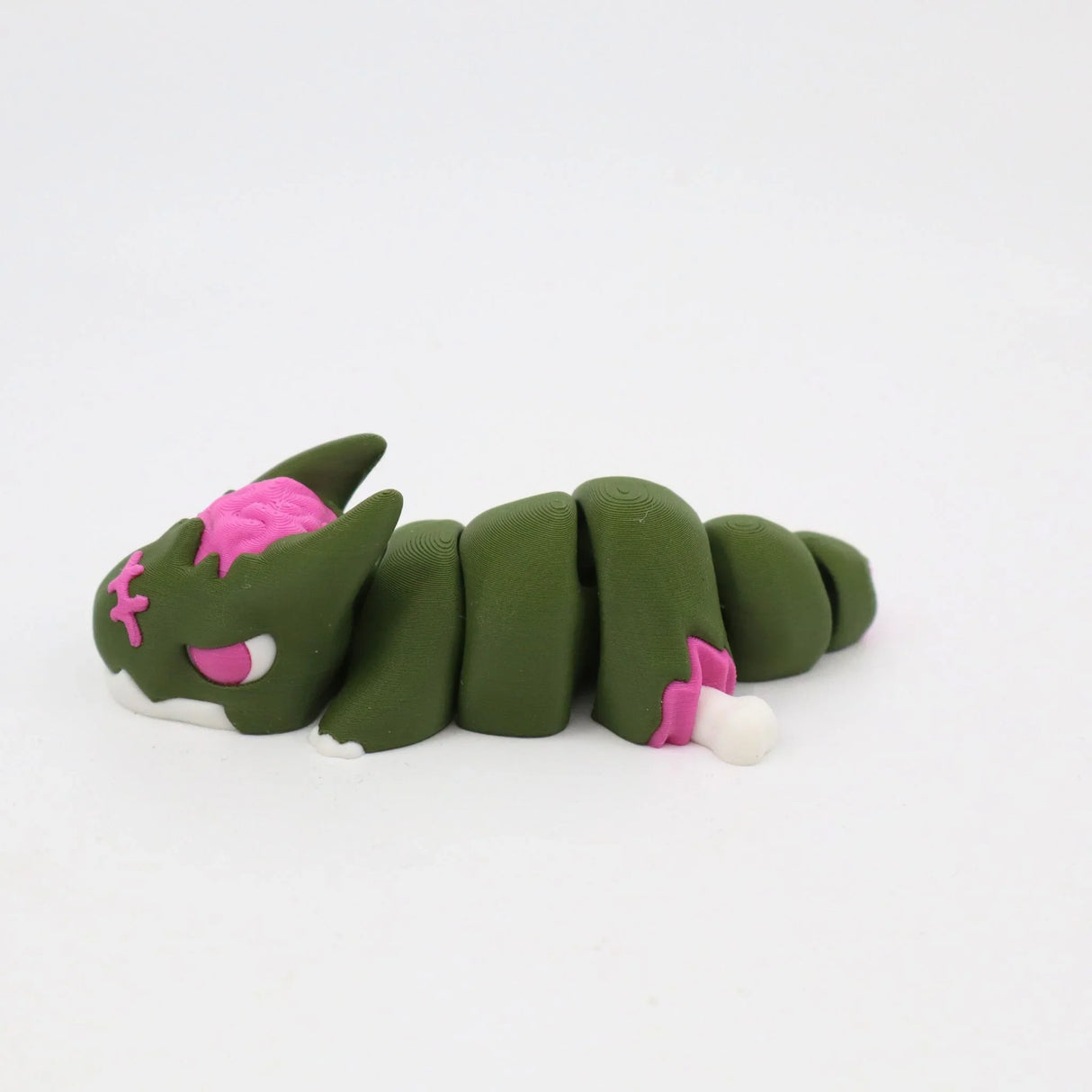Green and pink 3D printed segmented sensory toy cat on white background