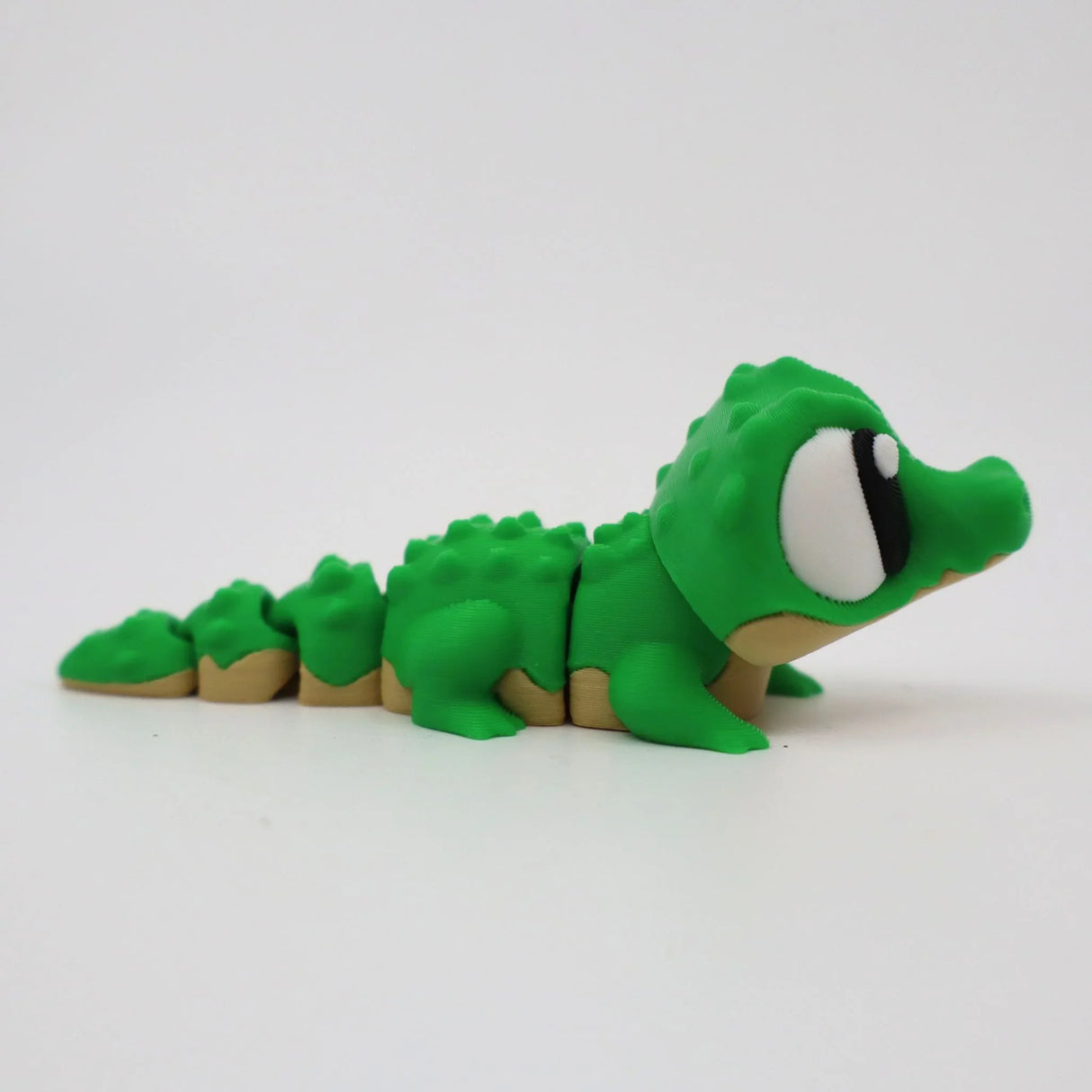 Green 3D printed alligator fidget toy with textured segments for sensory play