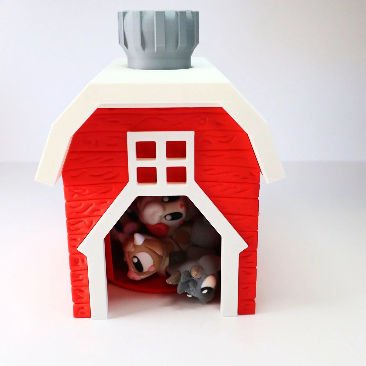 3D printed red barn sensory toy with animal figures inside, designed for sensory play
