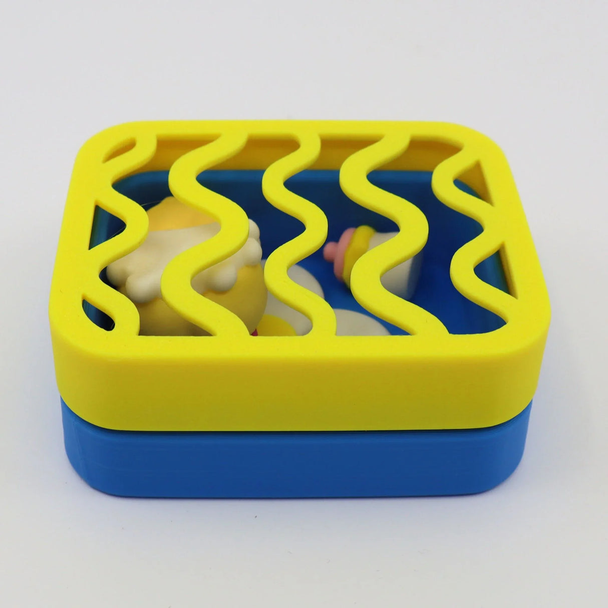 Colorful 3D printed sensory toy box with yellow wavy lid and blue base for kids