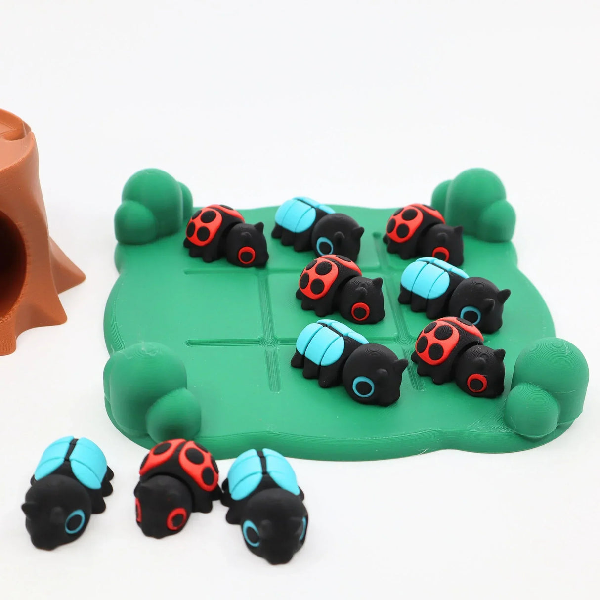 Colorful 3D printed ladybug and beetle sensory toys on green play mat for sensory seeking kids