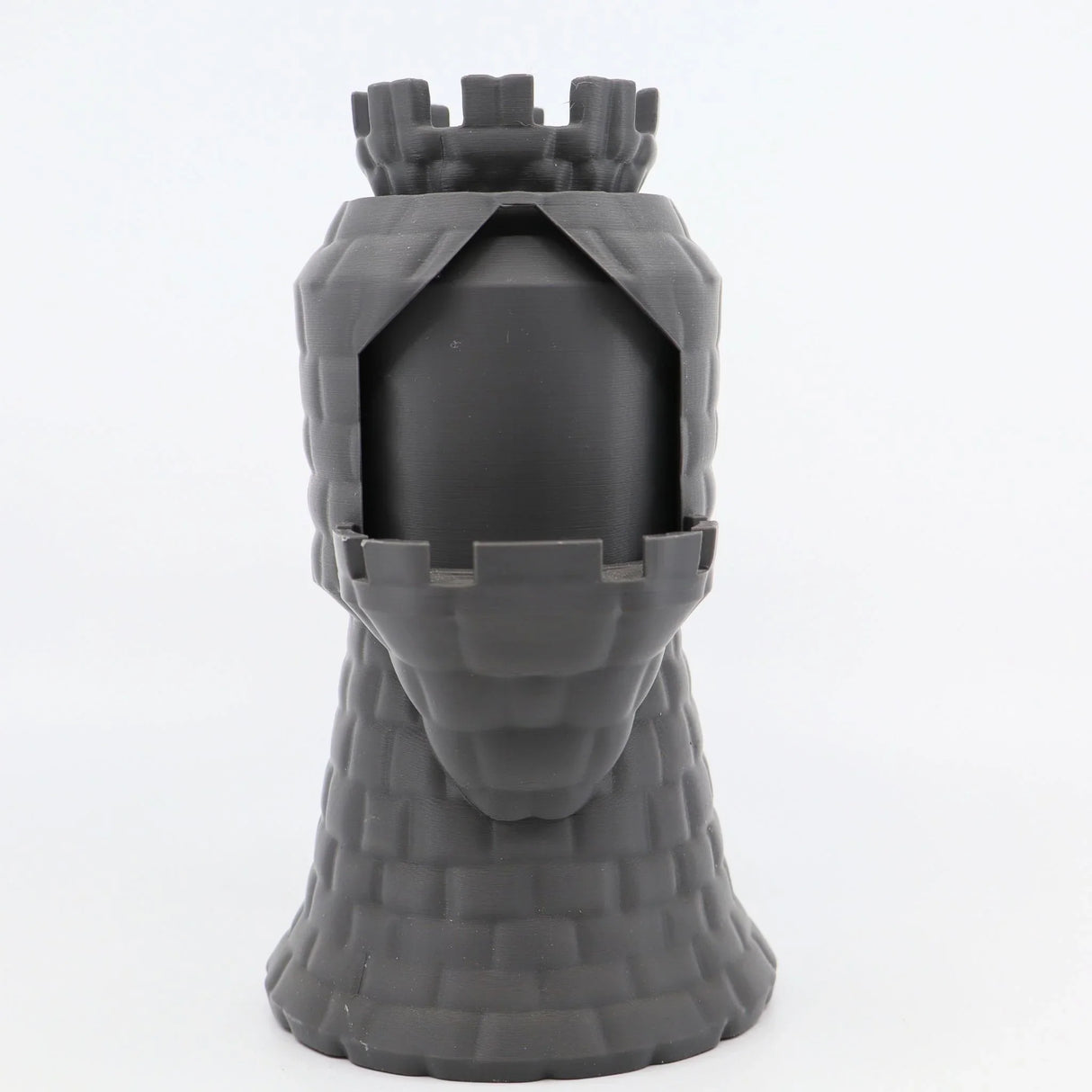 3D printed sensory toy resembling a gray dragon castle tower with textured walls