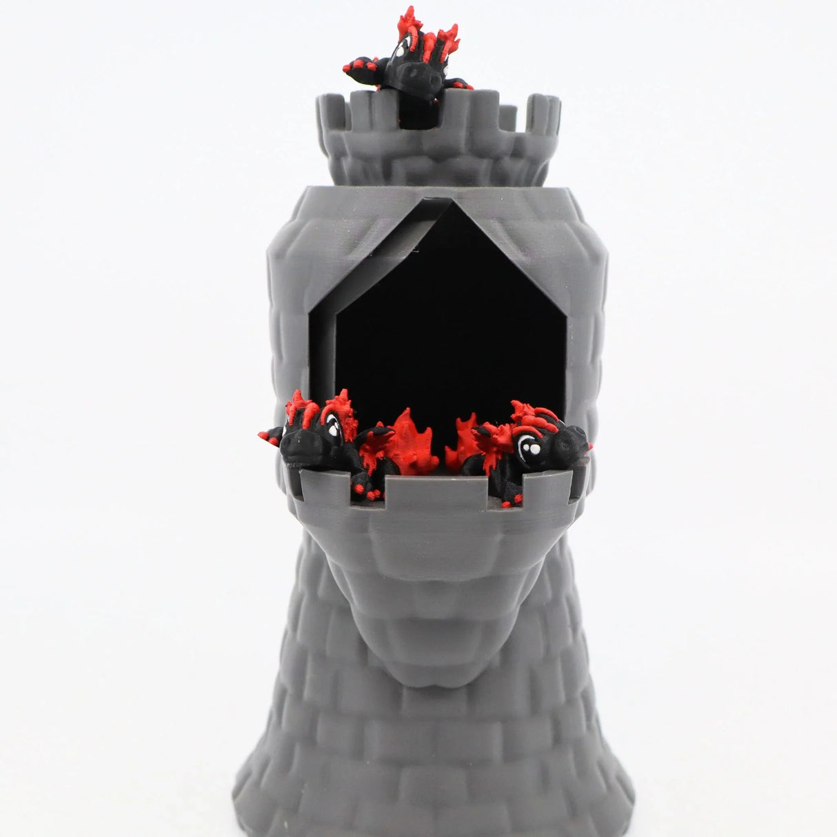 Gray 3D printed castle tower toy with small black and red dragon figures peeking out