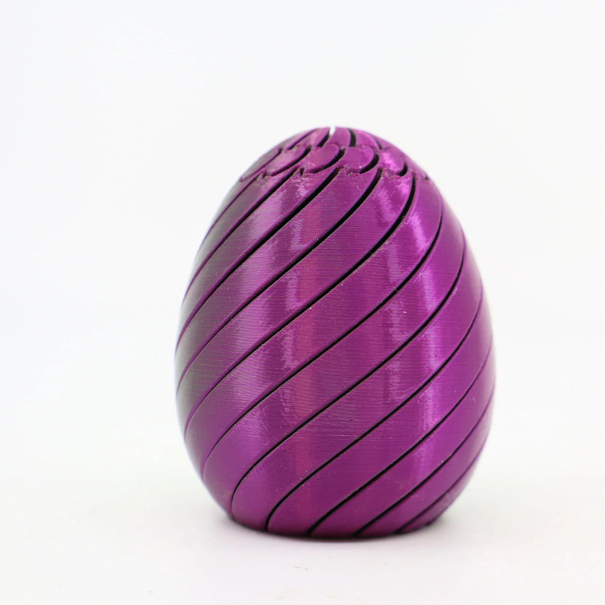 Purple 3D printed sensory egg toy with spiral grooves on white background