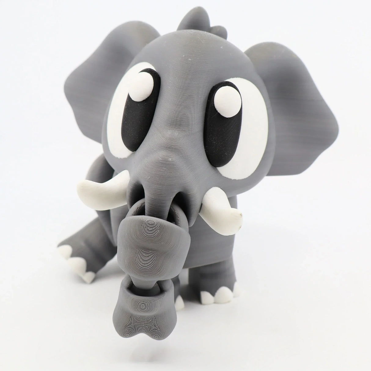3D printed gray elephant sensory toy with large eyes and movable trunk on white background