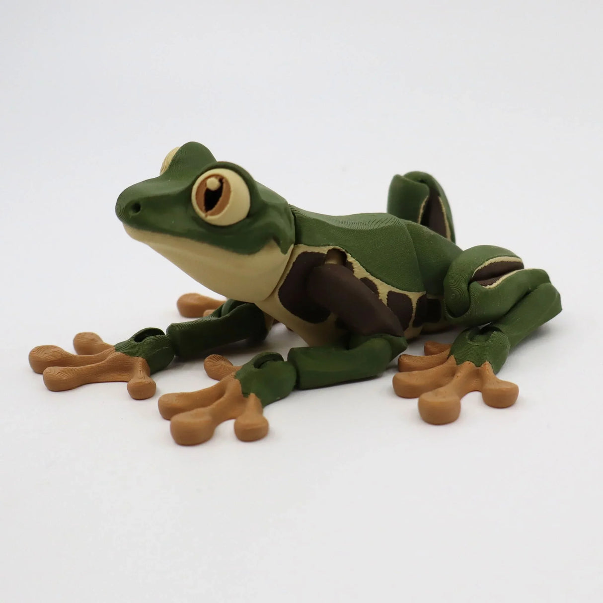 3D printed green and brown frog sensory toy with movable limbs on white background