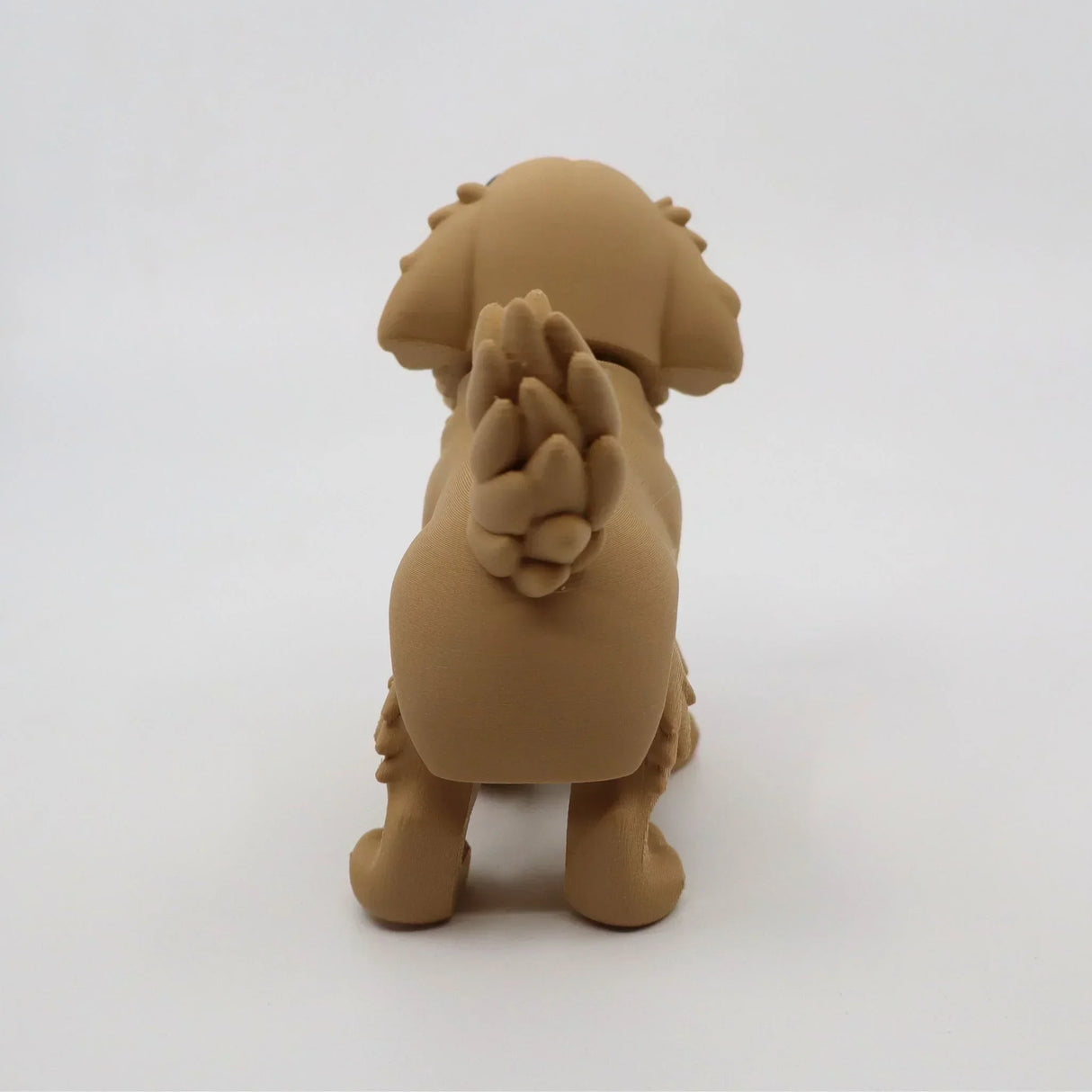 3D printed tan dog fidget toy with textured tail for sensory play