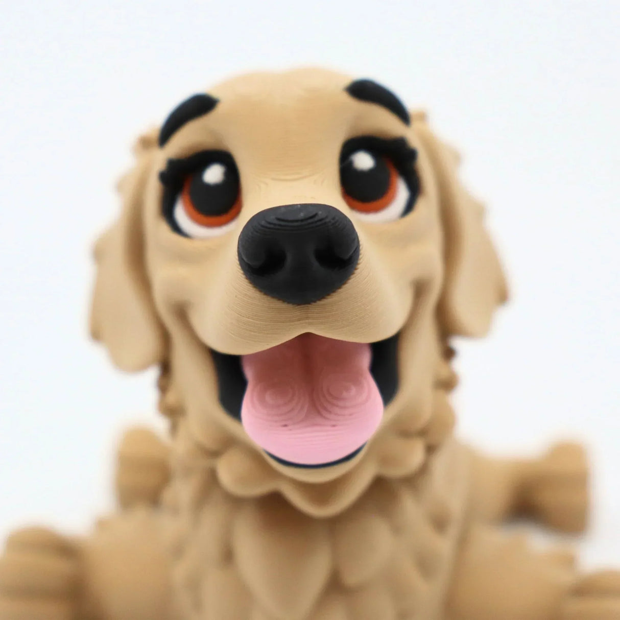 3D printed golden retriever fidget toy with expressive eyes and pink tongue for sensory play