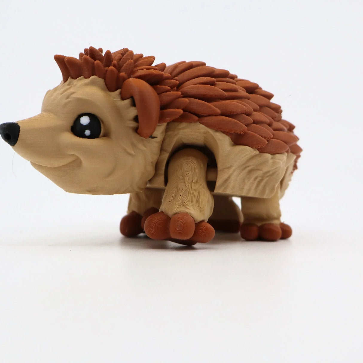 3D printed sensory hedgehog toy with brown textured spikes on white background