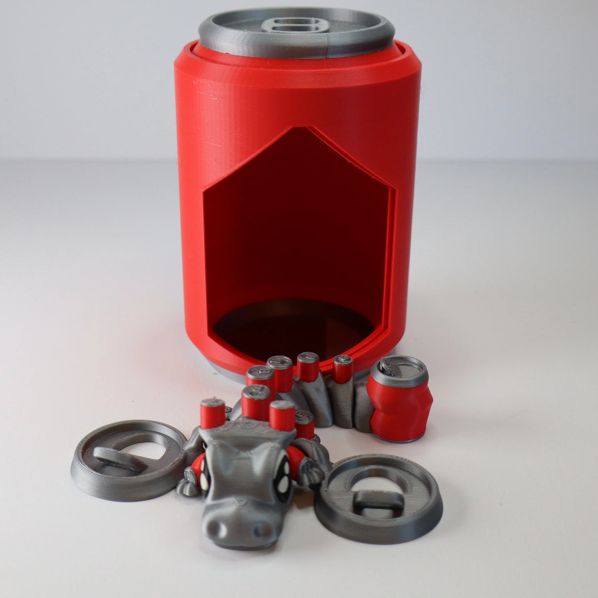 Colorful 3D printed sensory toy set shaped like a soda can, tabs, and playful animal.