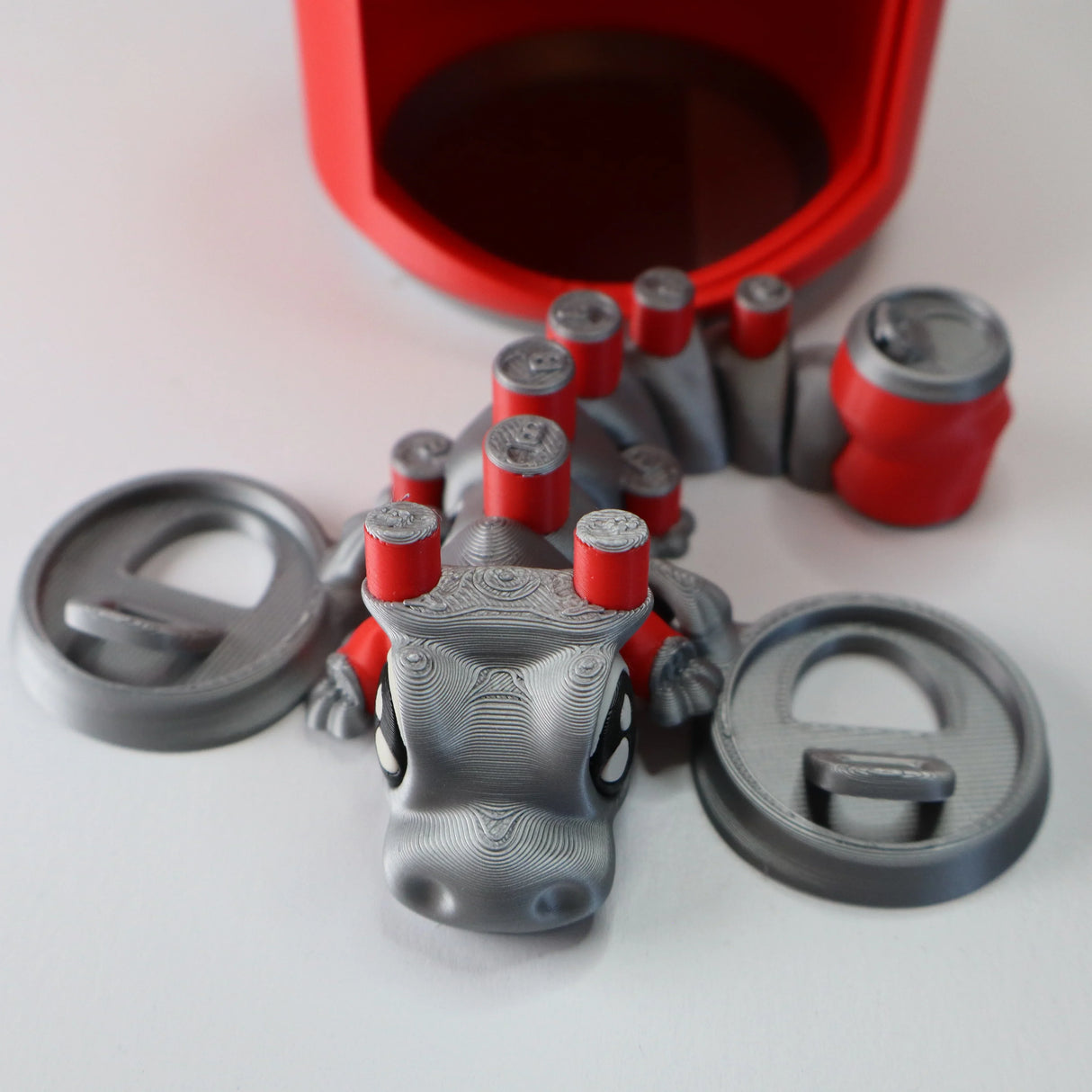 3D printed gray and red sensory fidget toy shaped like a lizard with detachable parts