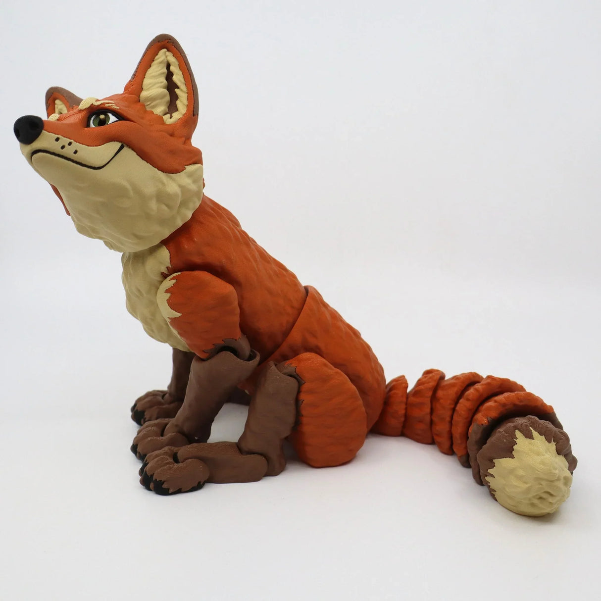 3D printed orange fox sensory toy with flexible joints, sitting on white background