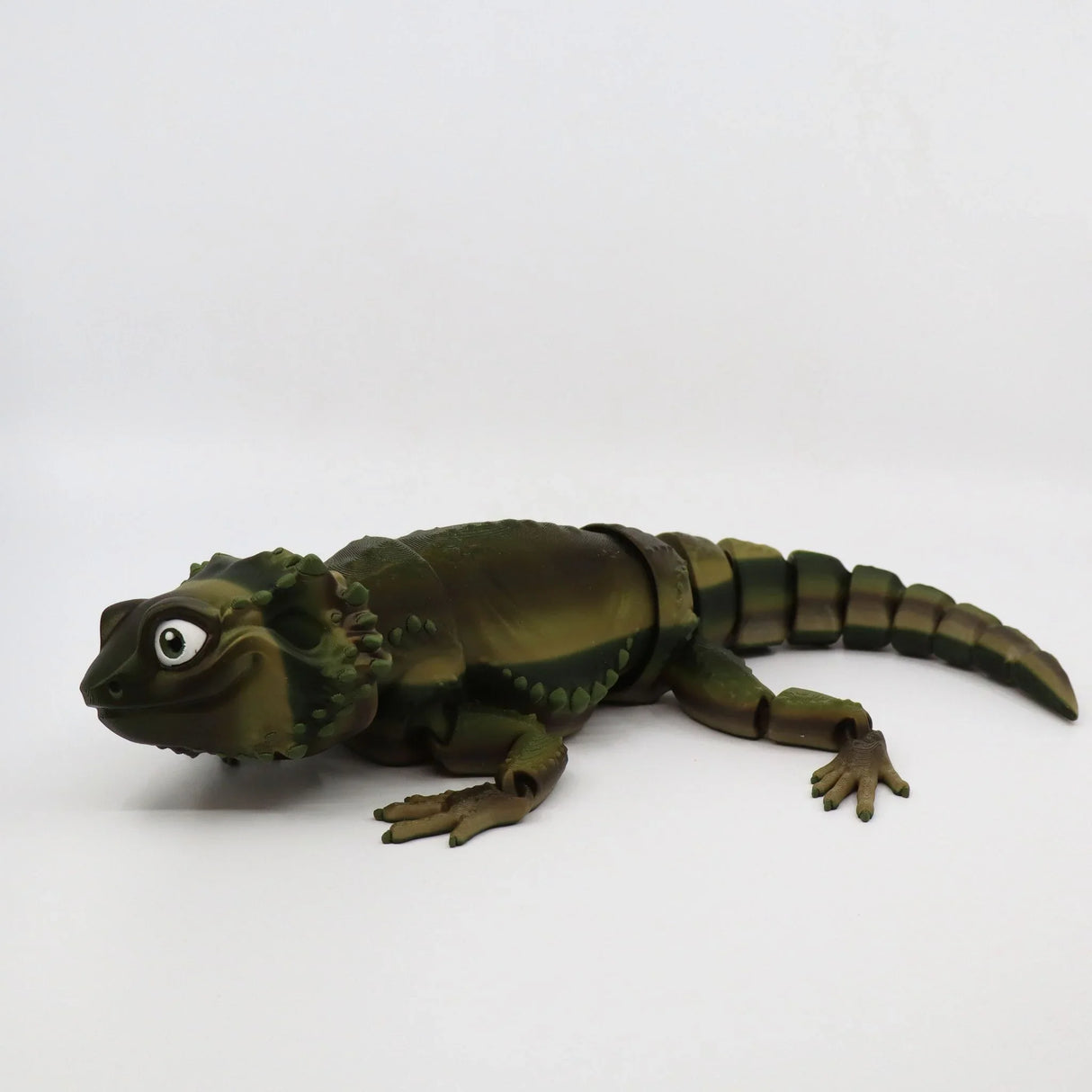 3D printed green lizard sensory toy with jointed body on white background