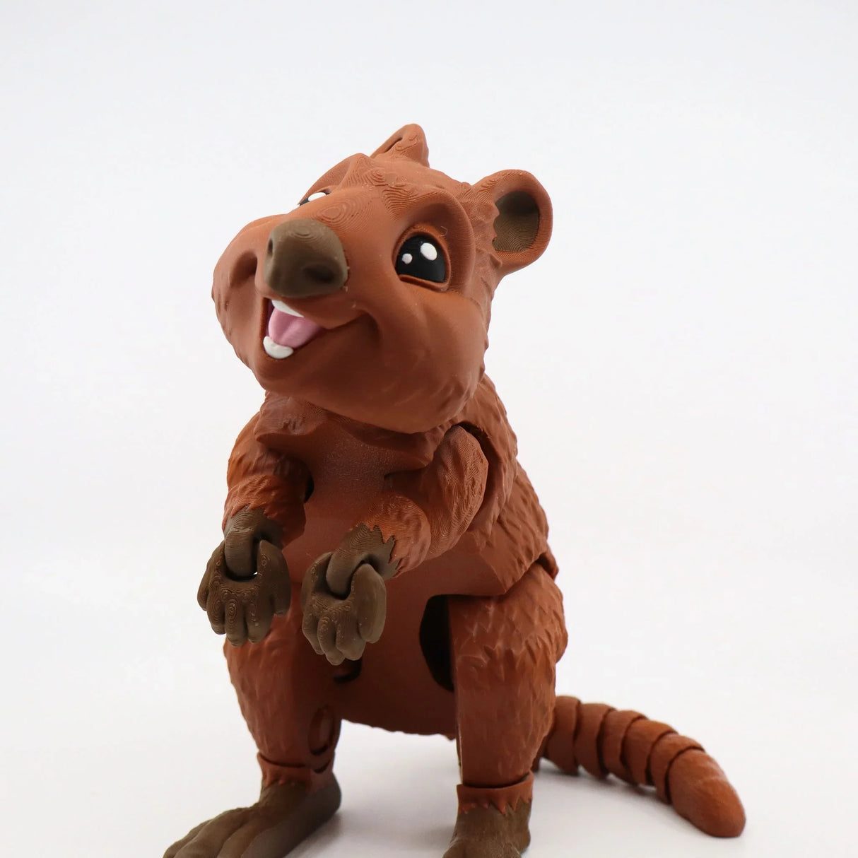 Smiling 3D printed brown quokka sensory toy with movable limbs on white background