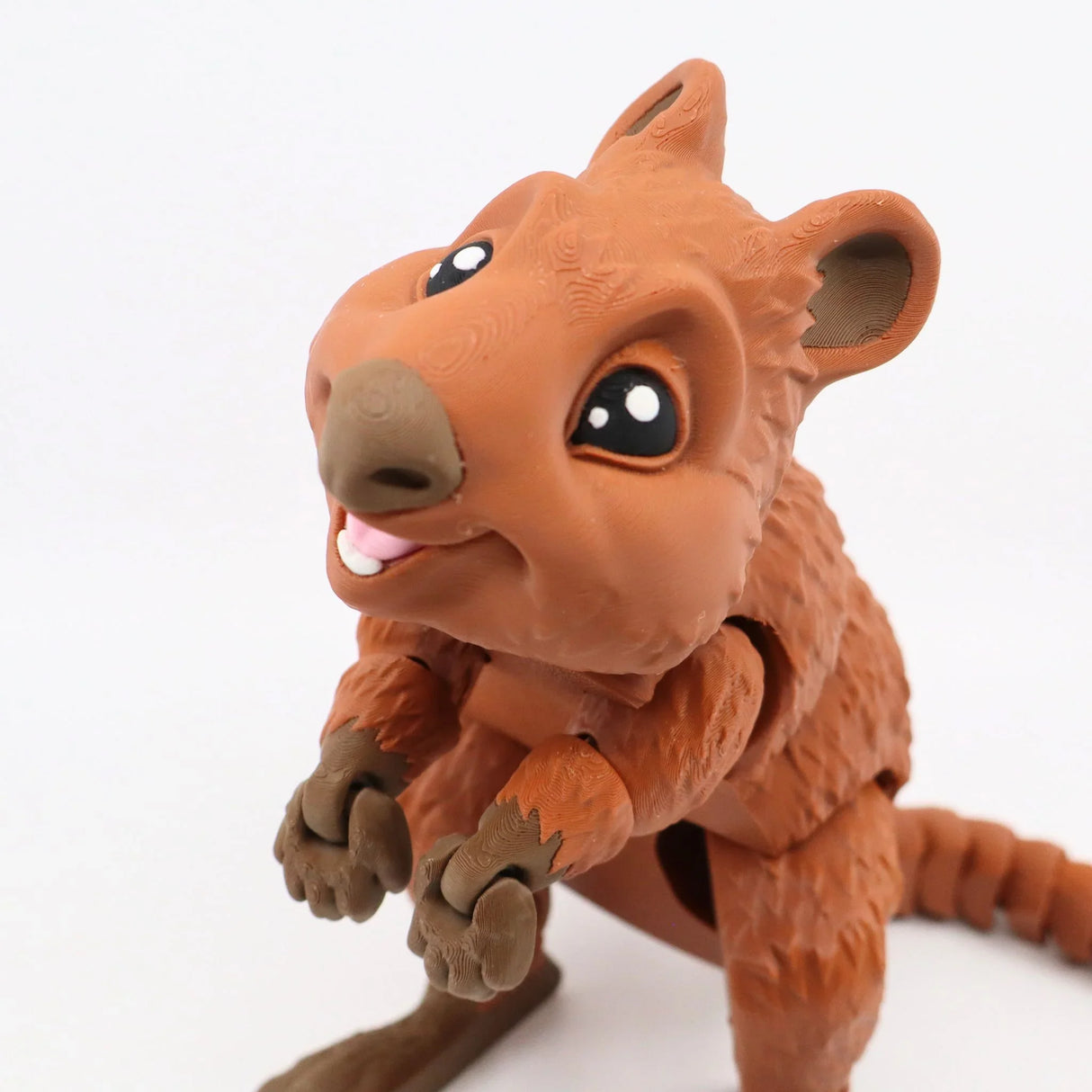 3D printed brown quokka sensory toy with movable limbs and a smiling face on white background