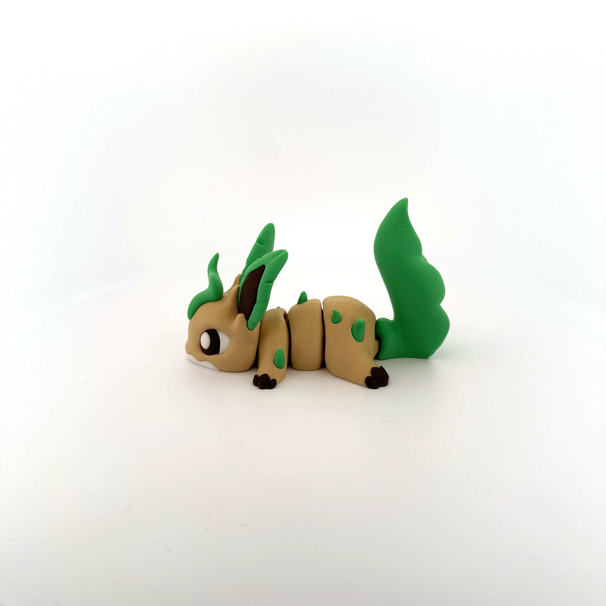 3D printed sensory toy of a cute green and tan animal with jointed segments