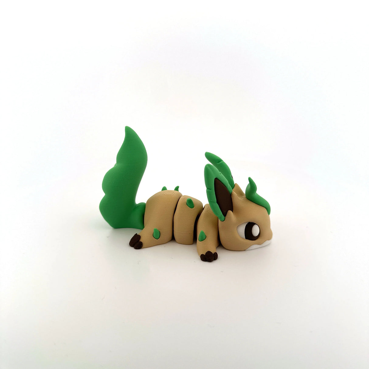 3D printed sensory toy resembling a cute, leafy animal with green tail and ears on white background.