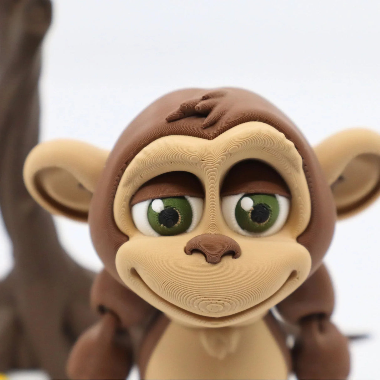 3D printed sensory monkey toy with large green eyes and detailed textures