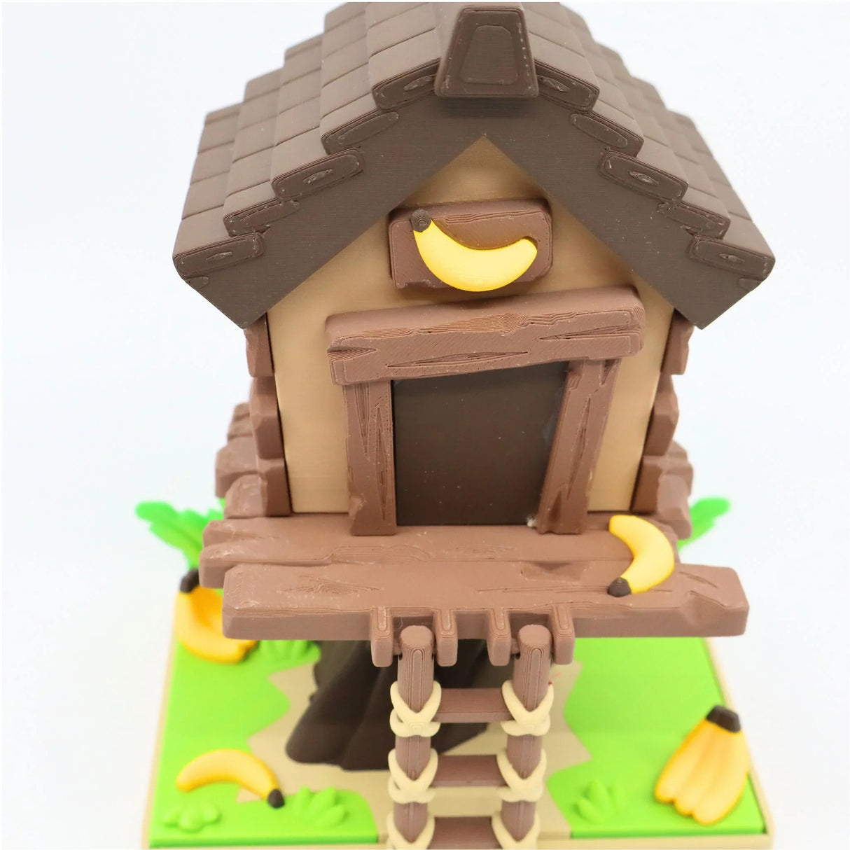3D printed sensory toy treehouse with a ladder and banana decorations for kids