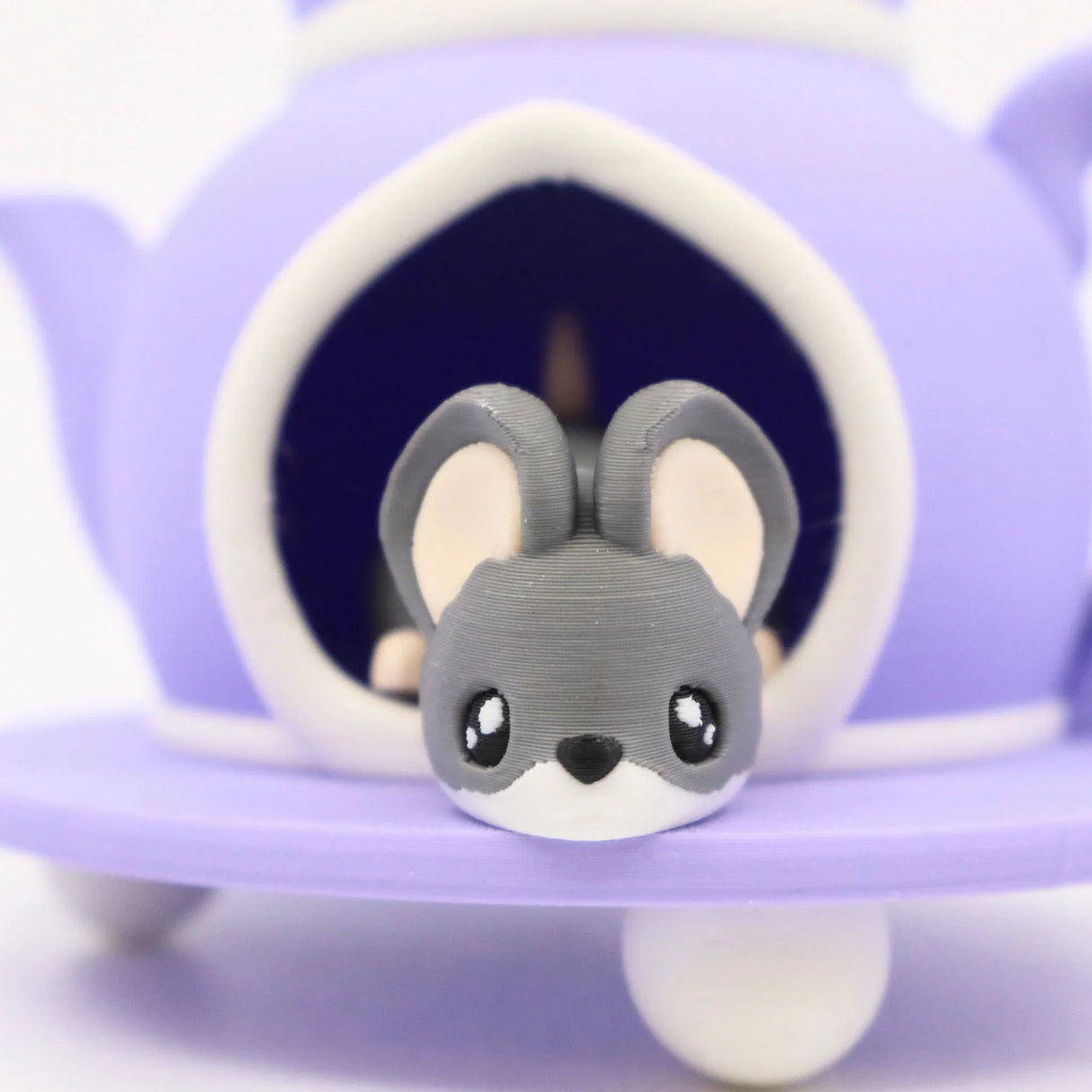 Cute 3D printed gray mouse toy peeking from purple teapot, sensory play figure