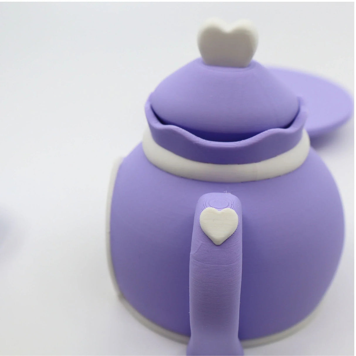 Purple 3D printed sensory toy teapot with white heart details, playful and kid-friendly design