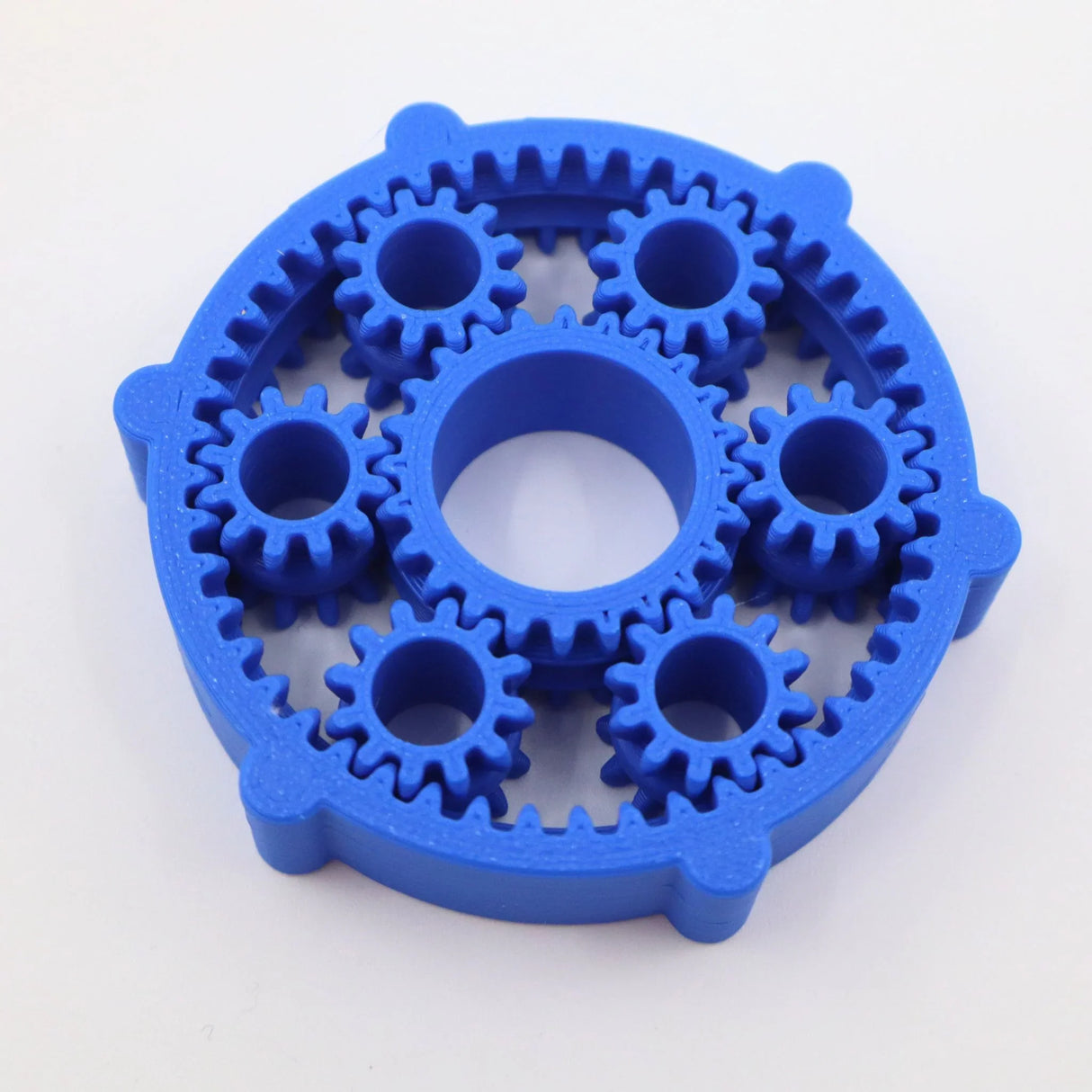 Blue 3D printed planetary gear fidget toy with seven interlocking gears