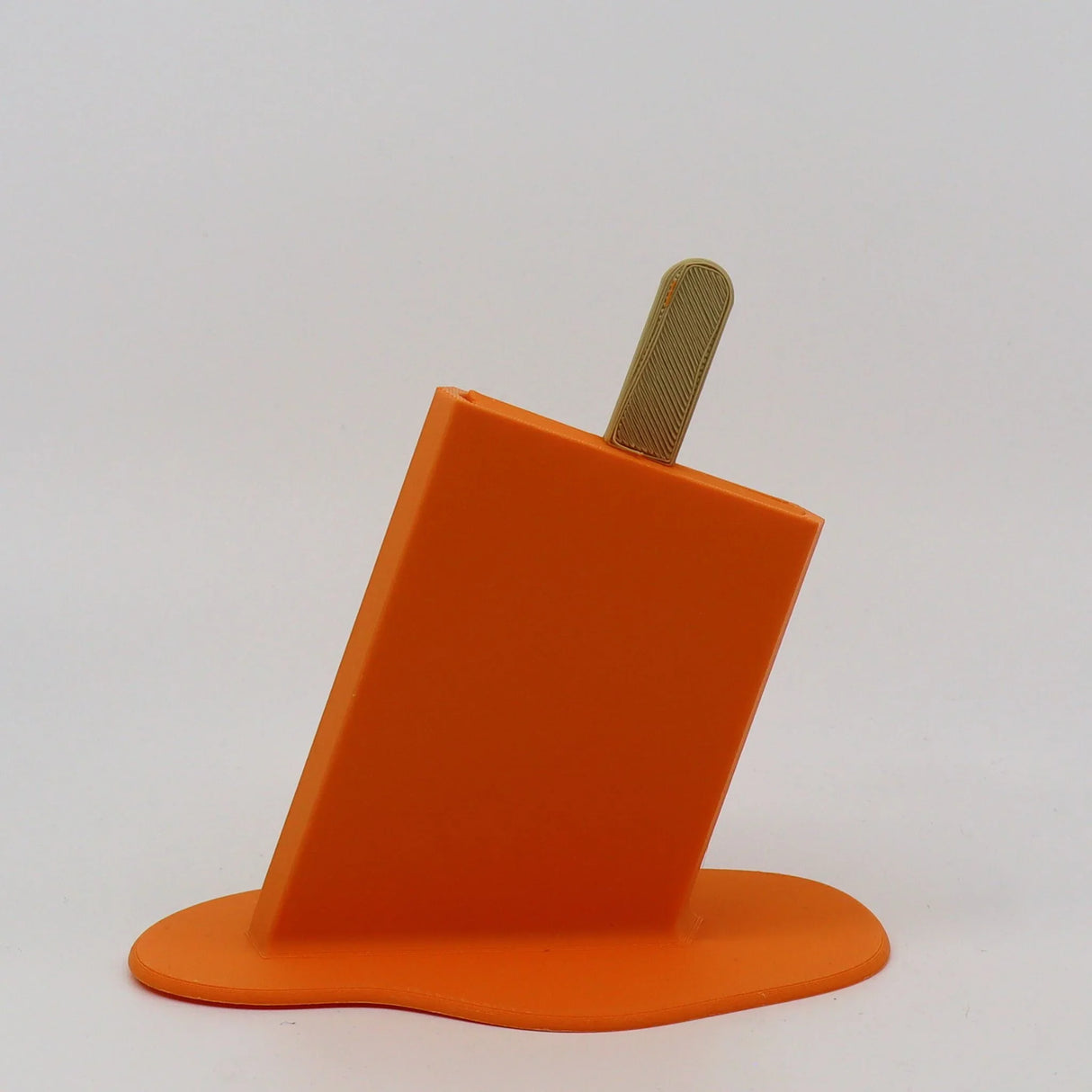 Orange 3D printed popsicle sensory toy with melting effect on white background