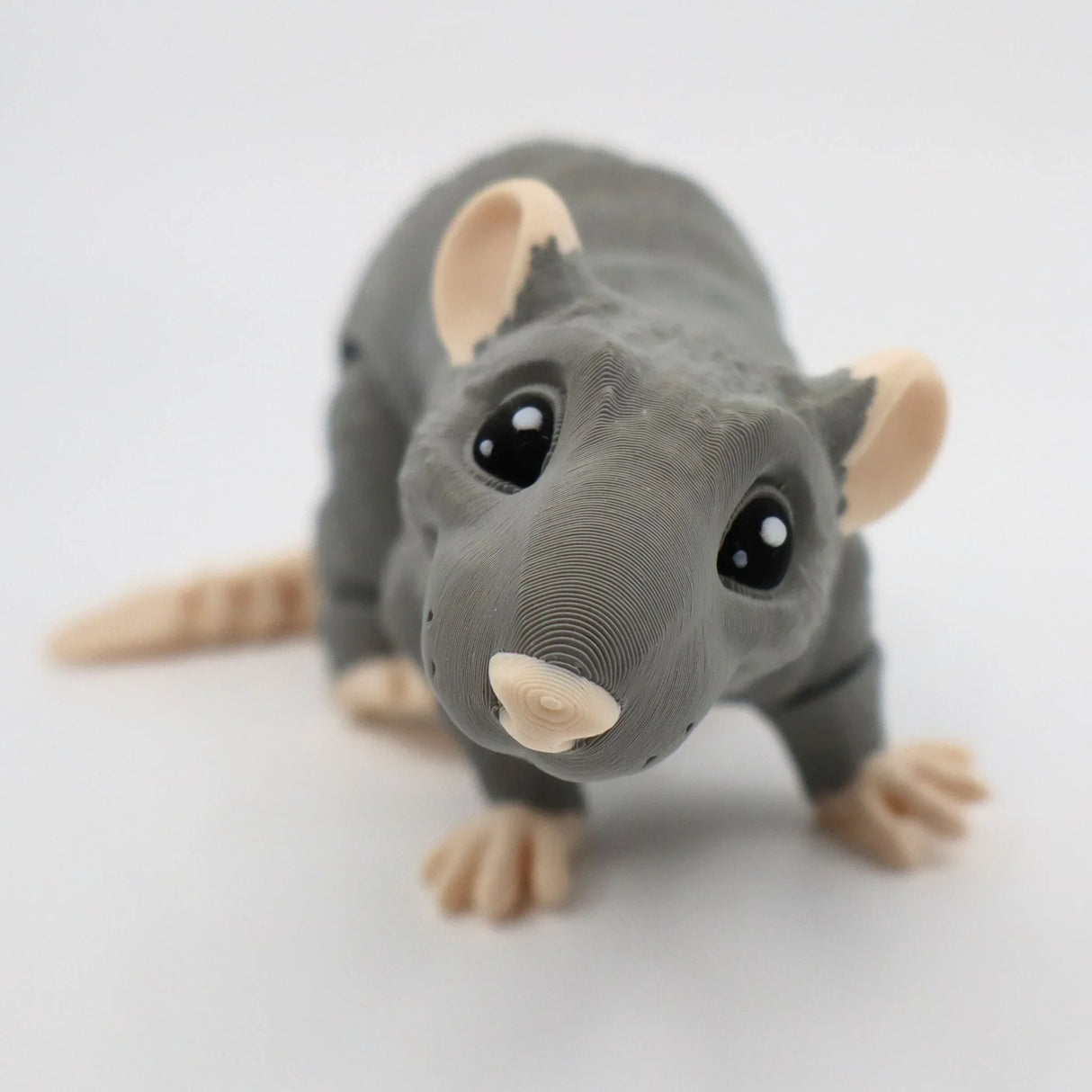 Cute gray 3D printed rat sensory toy with big eyes and beige paws on white background.