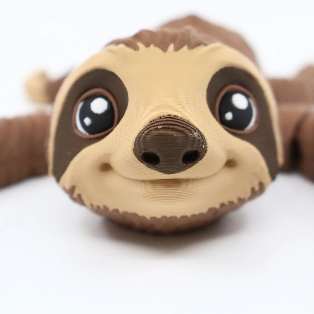 3D printed sloth sensory toy with big eyes on a white background