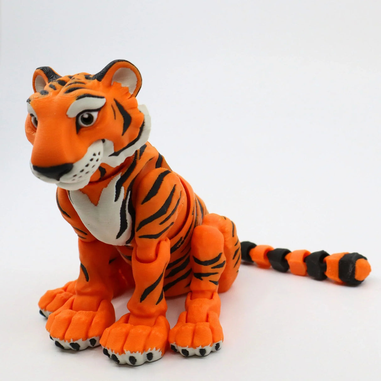 3D printed orange tiger sensory toy with flexible joints on white background