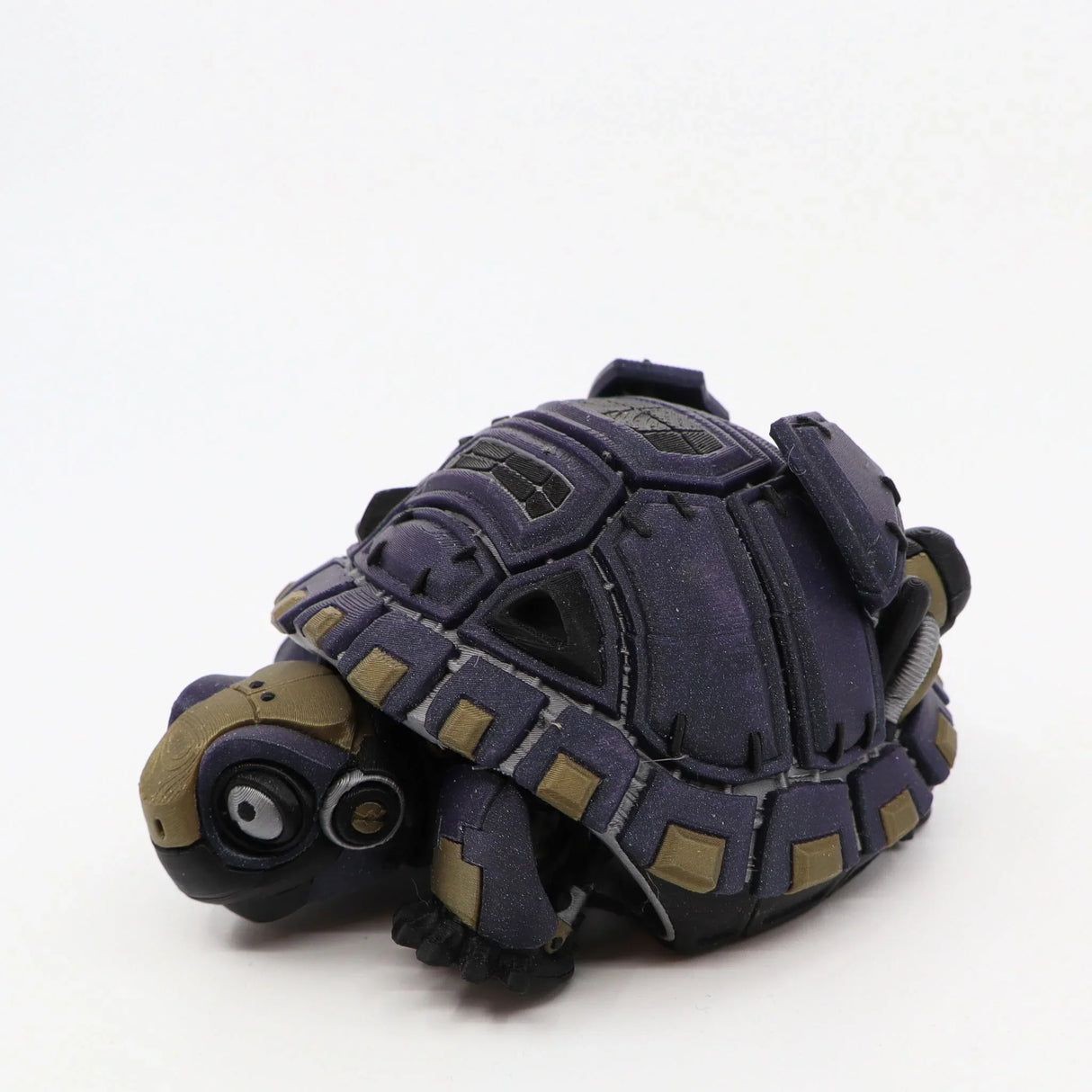 3D printed sensory tortoise toy with articulated shell and purple, tan, and black details