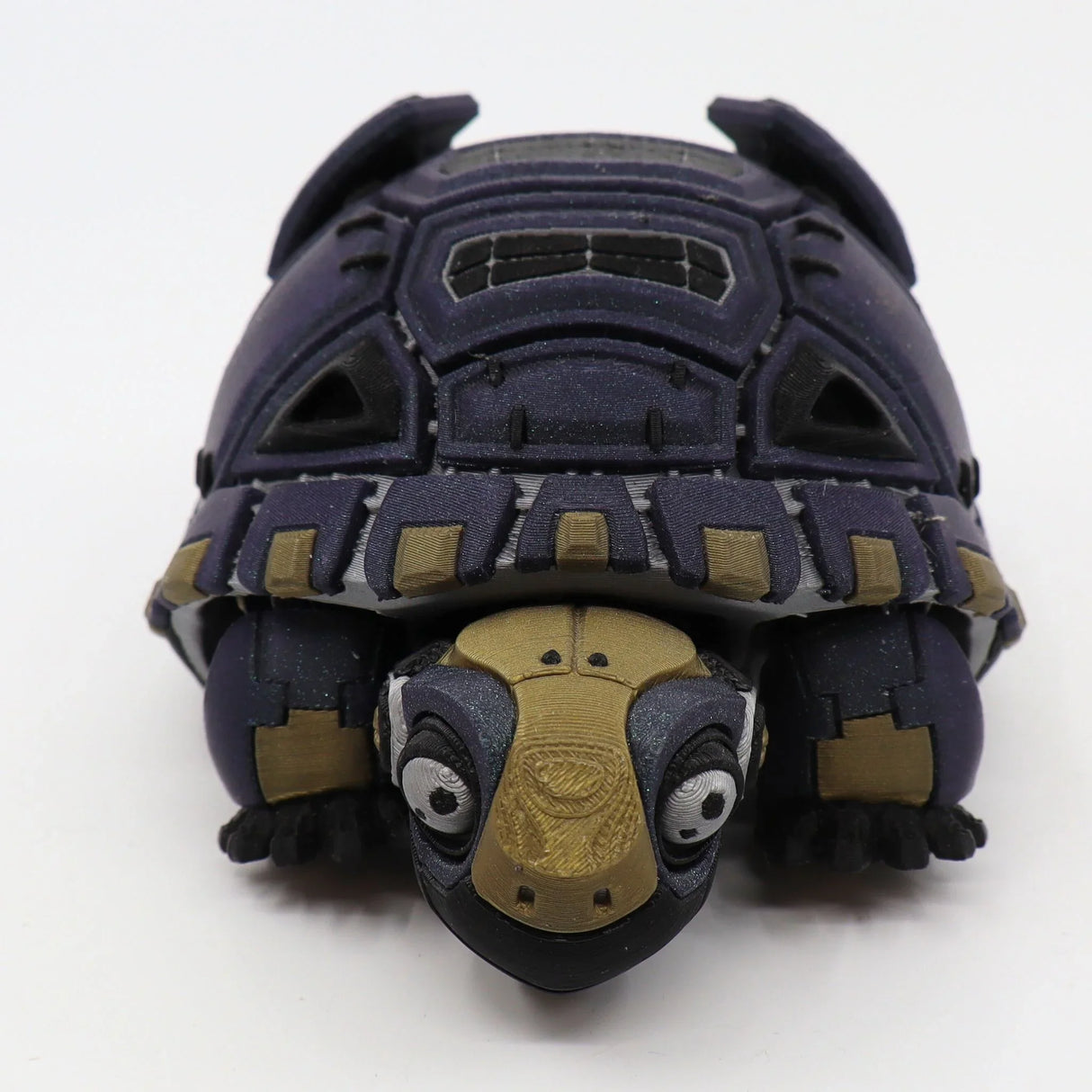 Purple and gold 3D printed sensory tortoise toy with articulated shell on white background