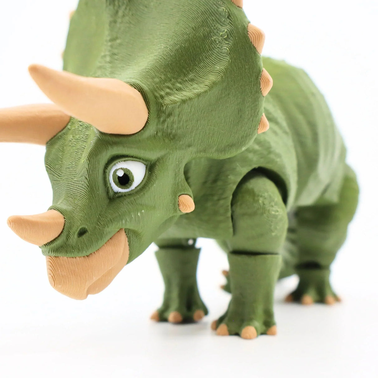 3D printed green triceratops sensory toy with textured surface for sensory play