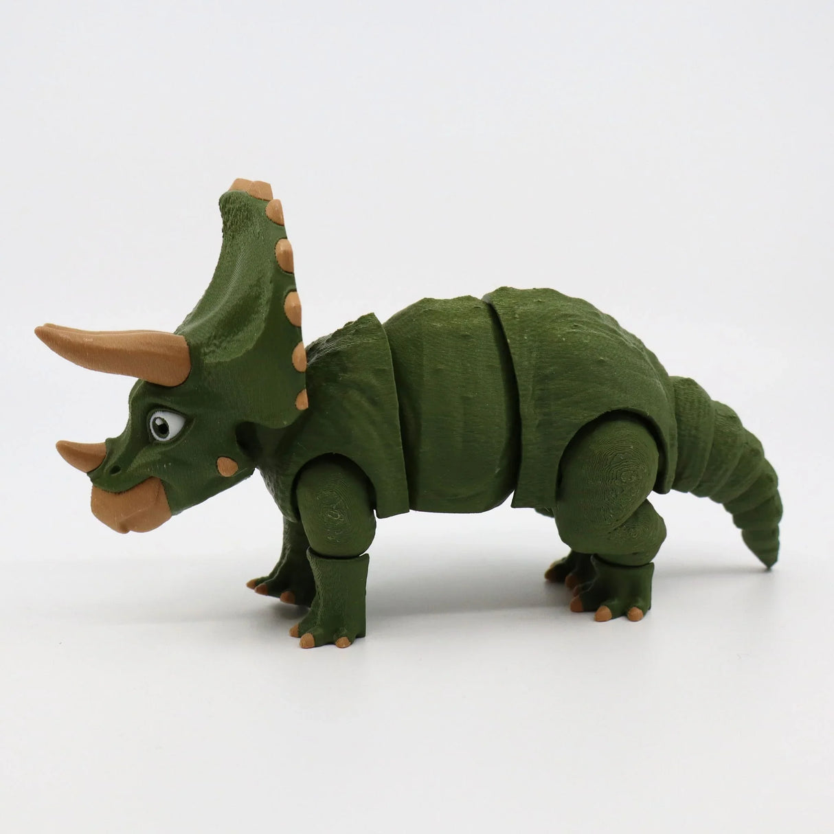 Green 3D printed triceratops sensory toy with jointed limbs on white background