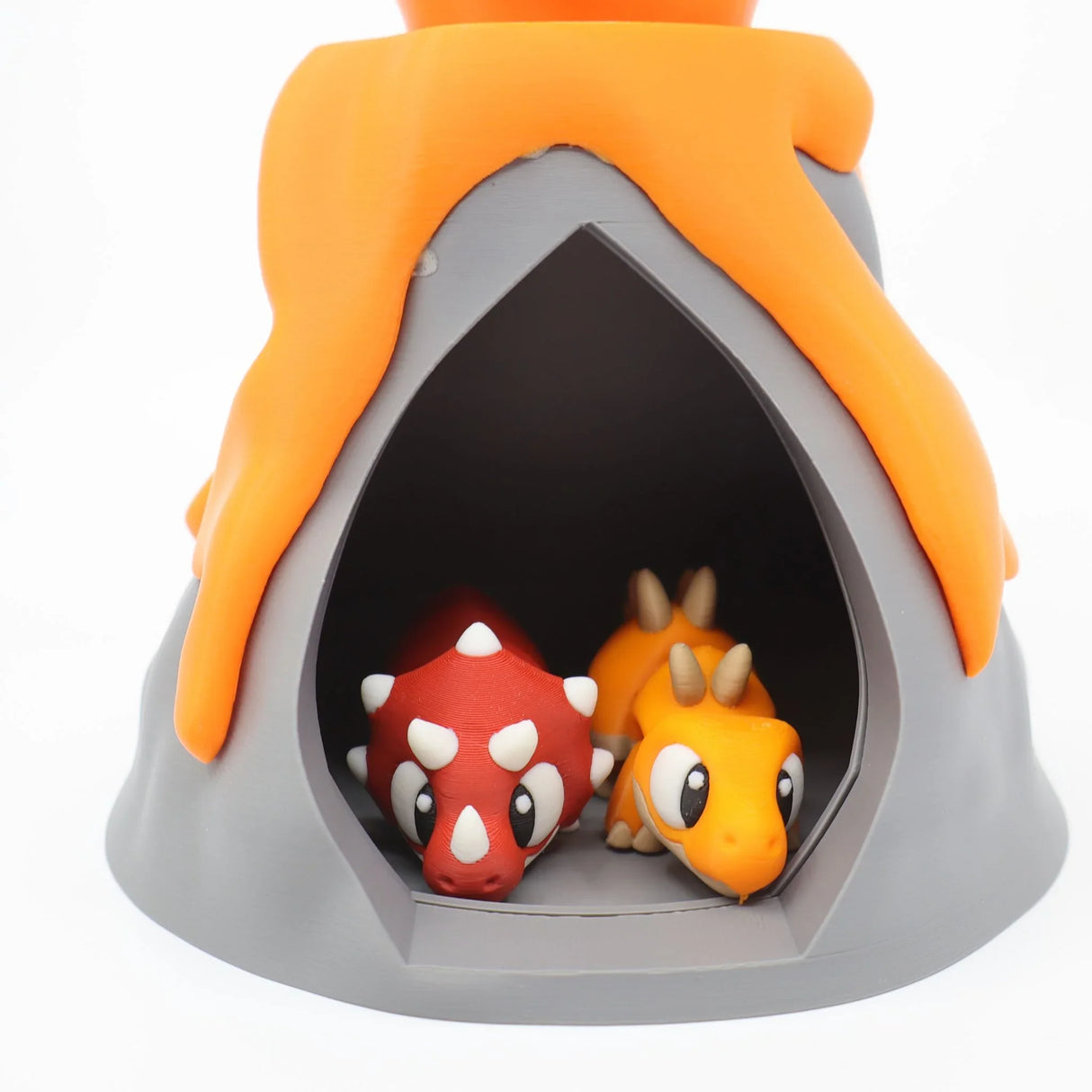 3D printed volcano sensory toy with two cute dinosaur figures inside