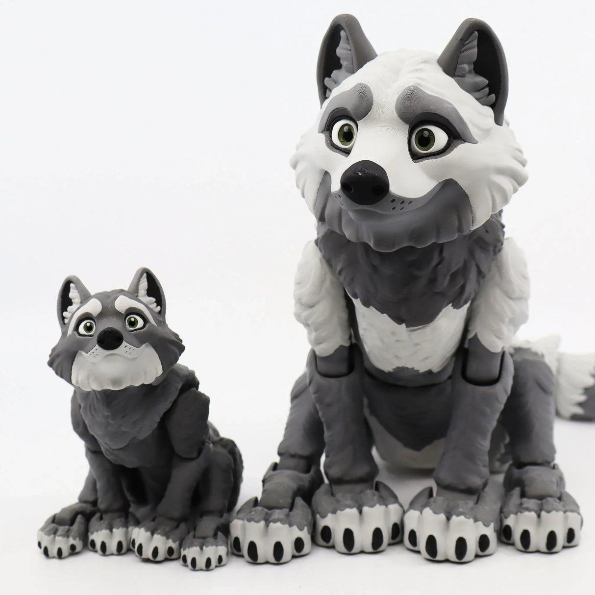 Two gray and white 3D printed wolf sensory toys with expressive faces on a white background.
