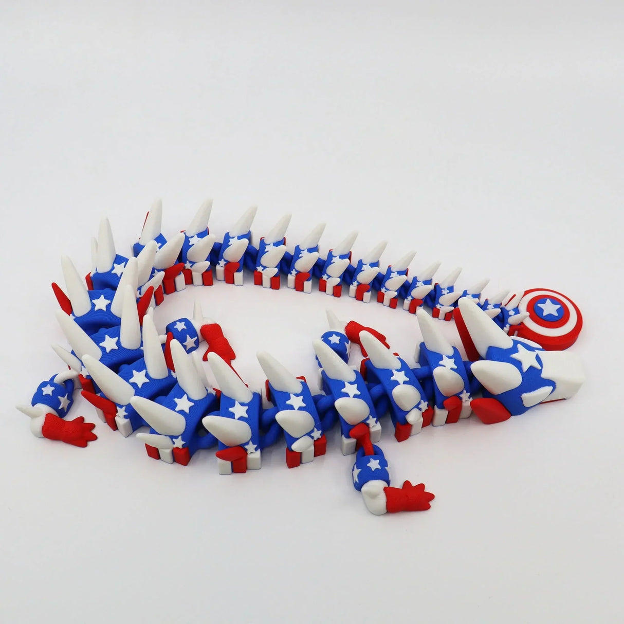 Red, white, and blue 3D printed flexi animal fidget toy with stars and shield, ideal for sensory play