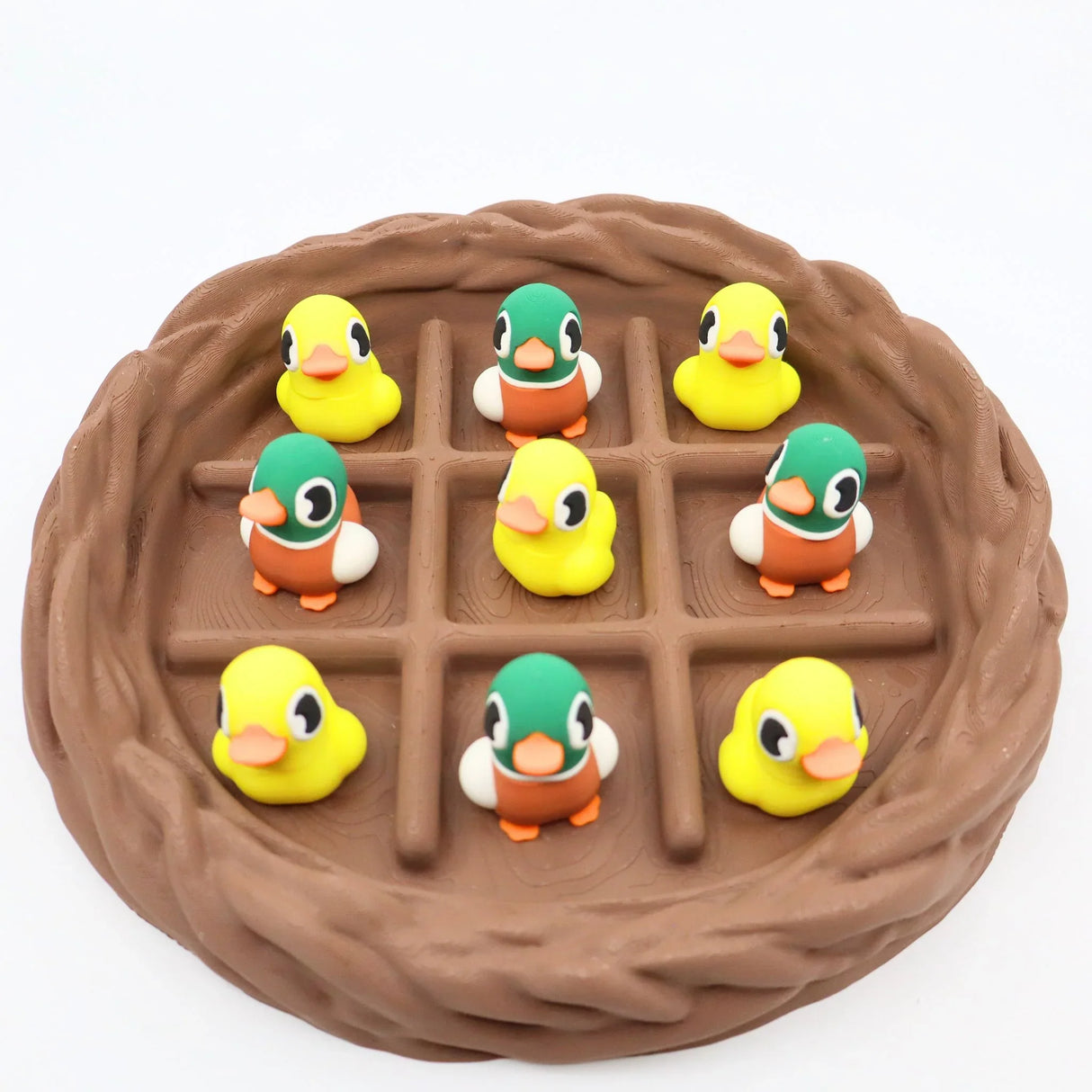Colorful 3D printed duck fidget toys in a brown nest grid, sensory play for kids