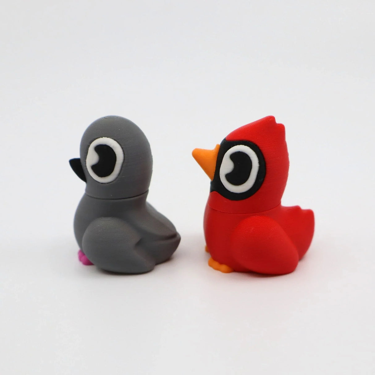 3D printed sensory bird fidget toys in gray and red, designed for tactile play and focus
