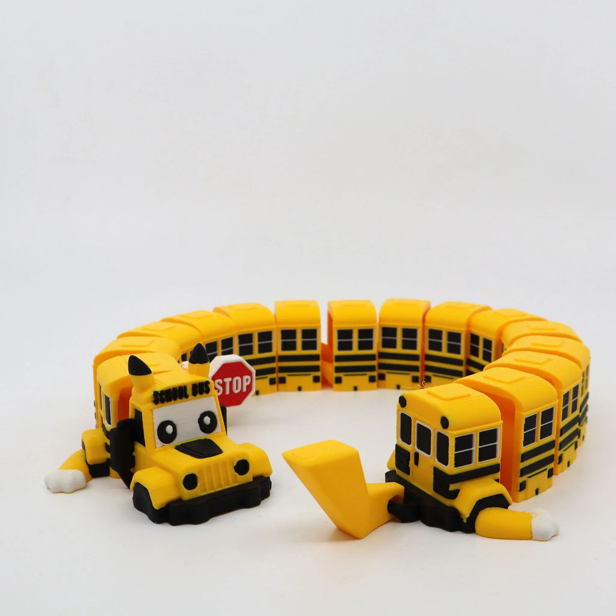 3D printed yellow school bus fidget toy with flexible segments and stop sign, sensory-friendly design