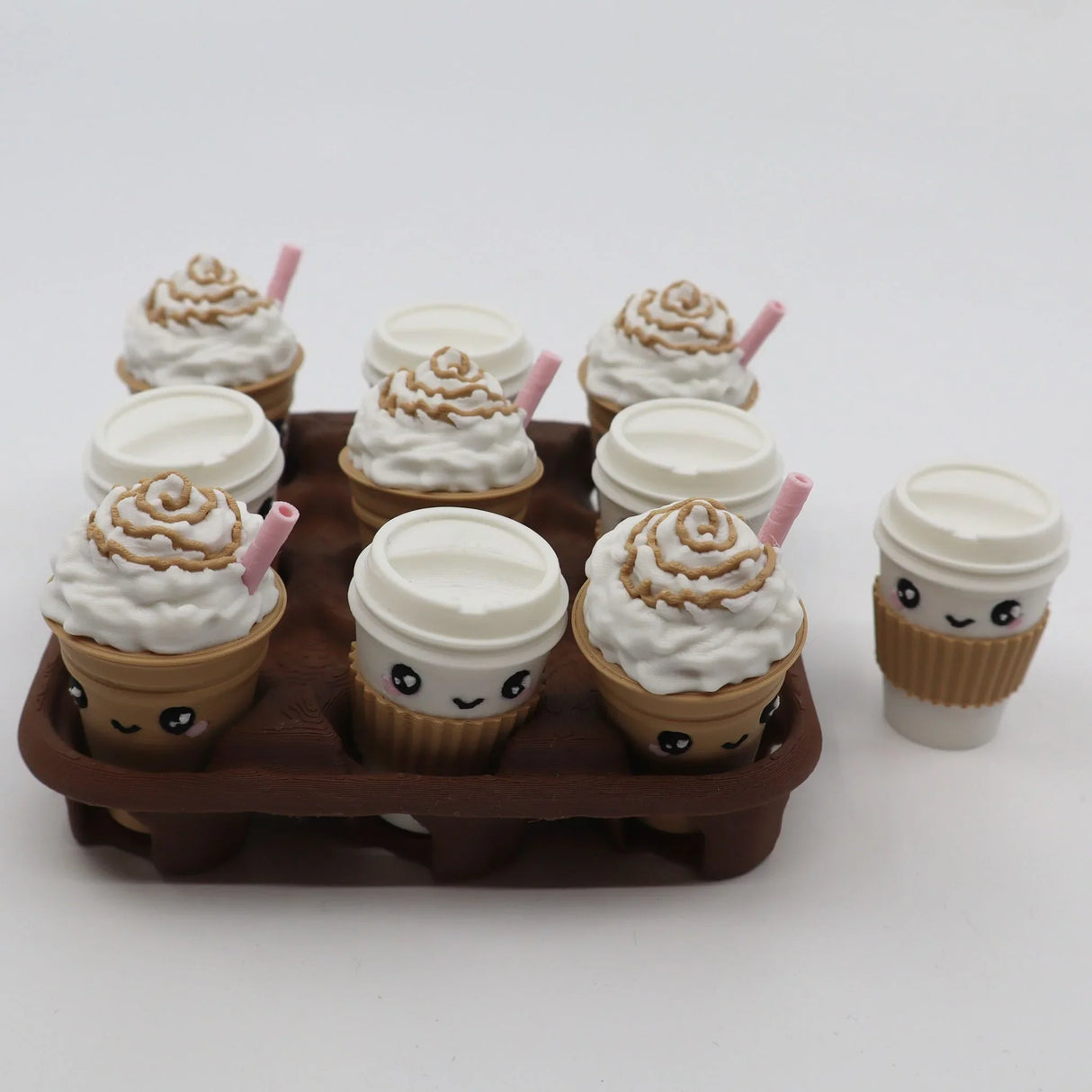 Cute coffee-themed tic-tac-toe sensory toy with 3D printed smiling cups and whipped cream tops