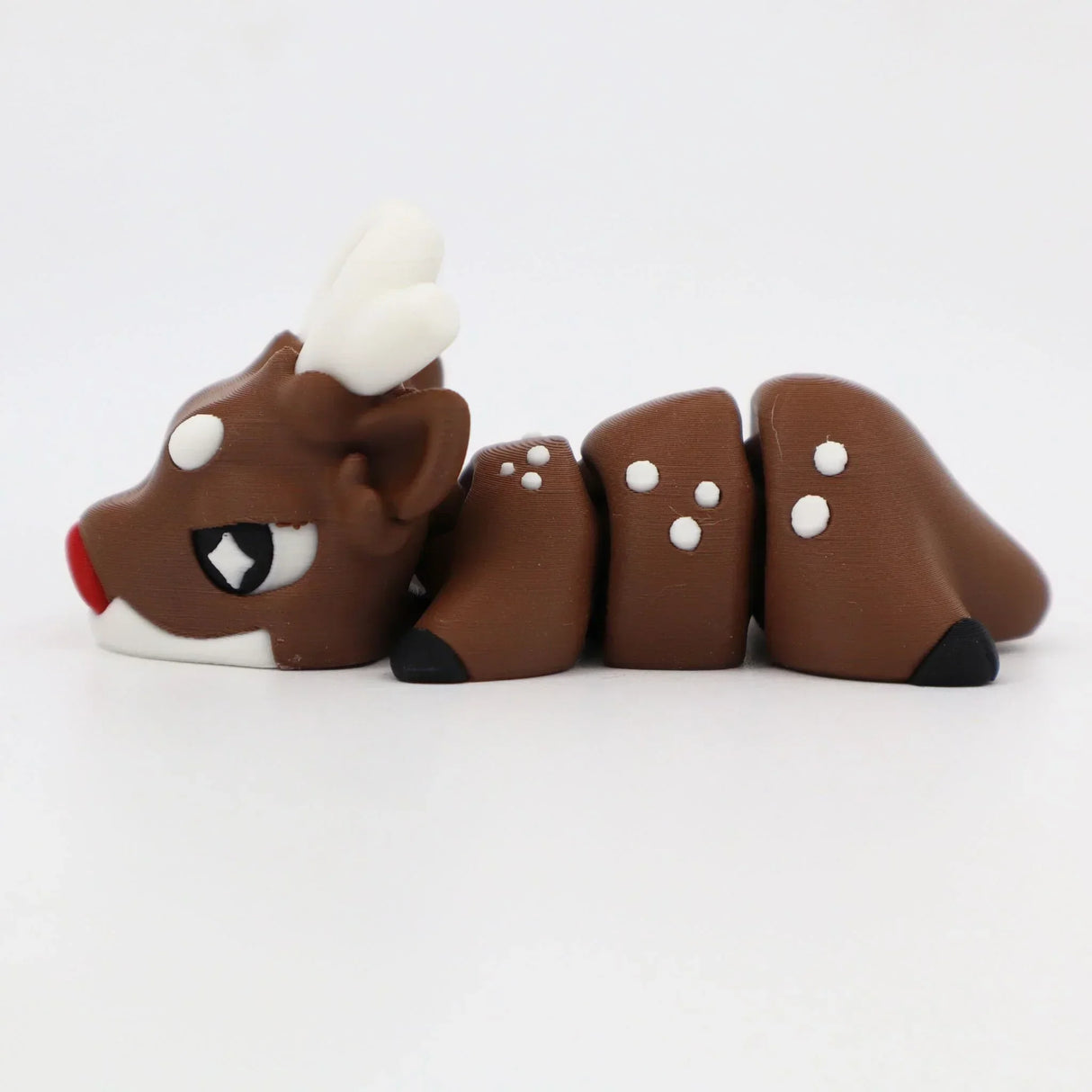 3D printed flexible brown reindeer sensory toy with white antlers and red nose on white background