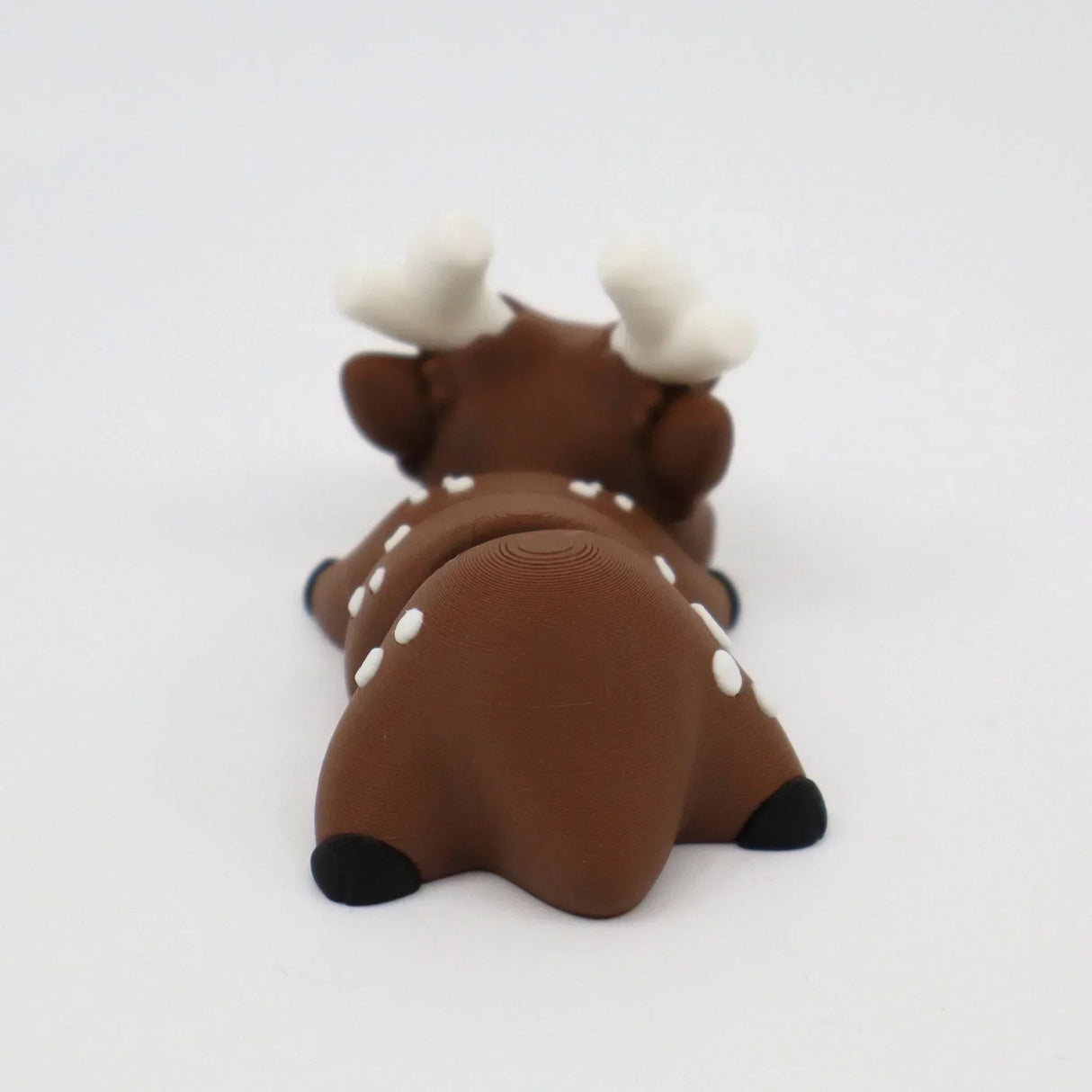 Brown 3D printed fawn sensory toy with white spots and antlers on a white background