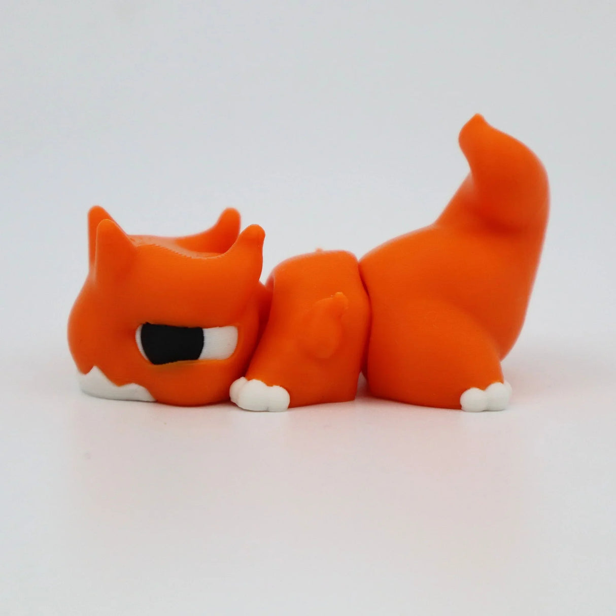 Orange 3D printed flexi fox fidget toy with white paws, designed for sensory play and tactile stimulation.