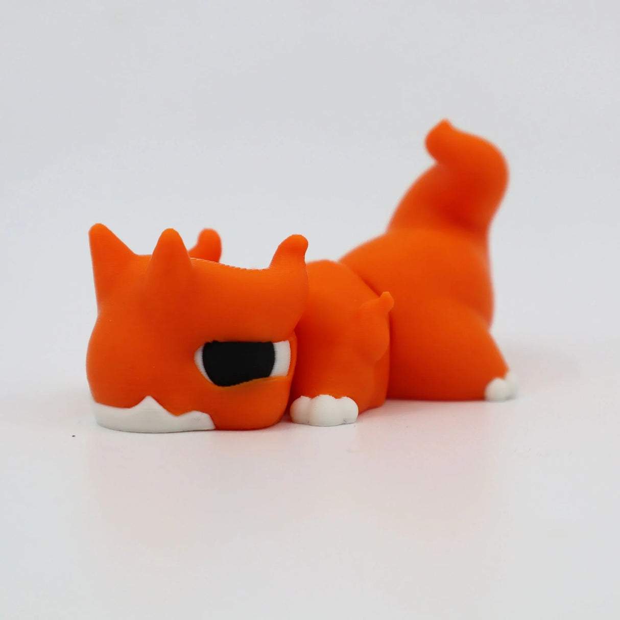Orange 3D printed flexi fox fidget toy with white paws, sensory-friendly design for kids