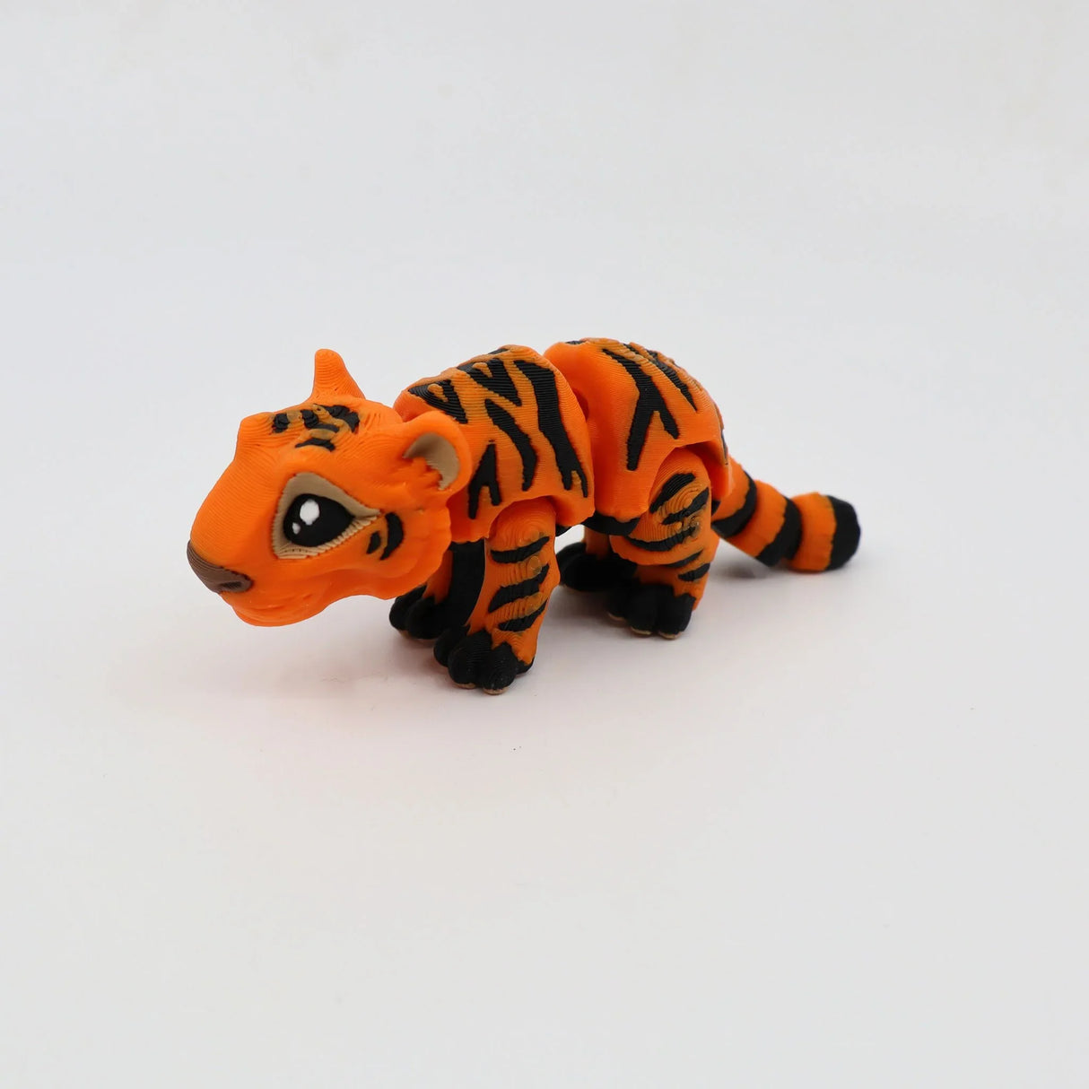 3D printed orange tiger fidget toy with black stripes on a white background