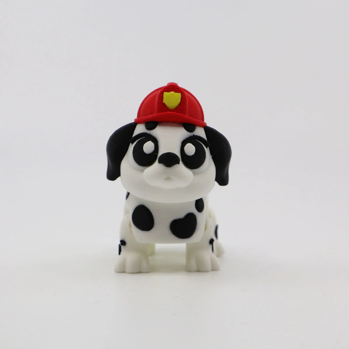 3D printed Dalmatian puppy fidget toy with red firefighter hat, sensory-friendly design for kids