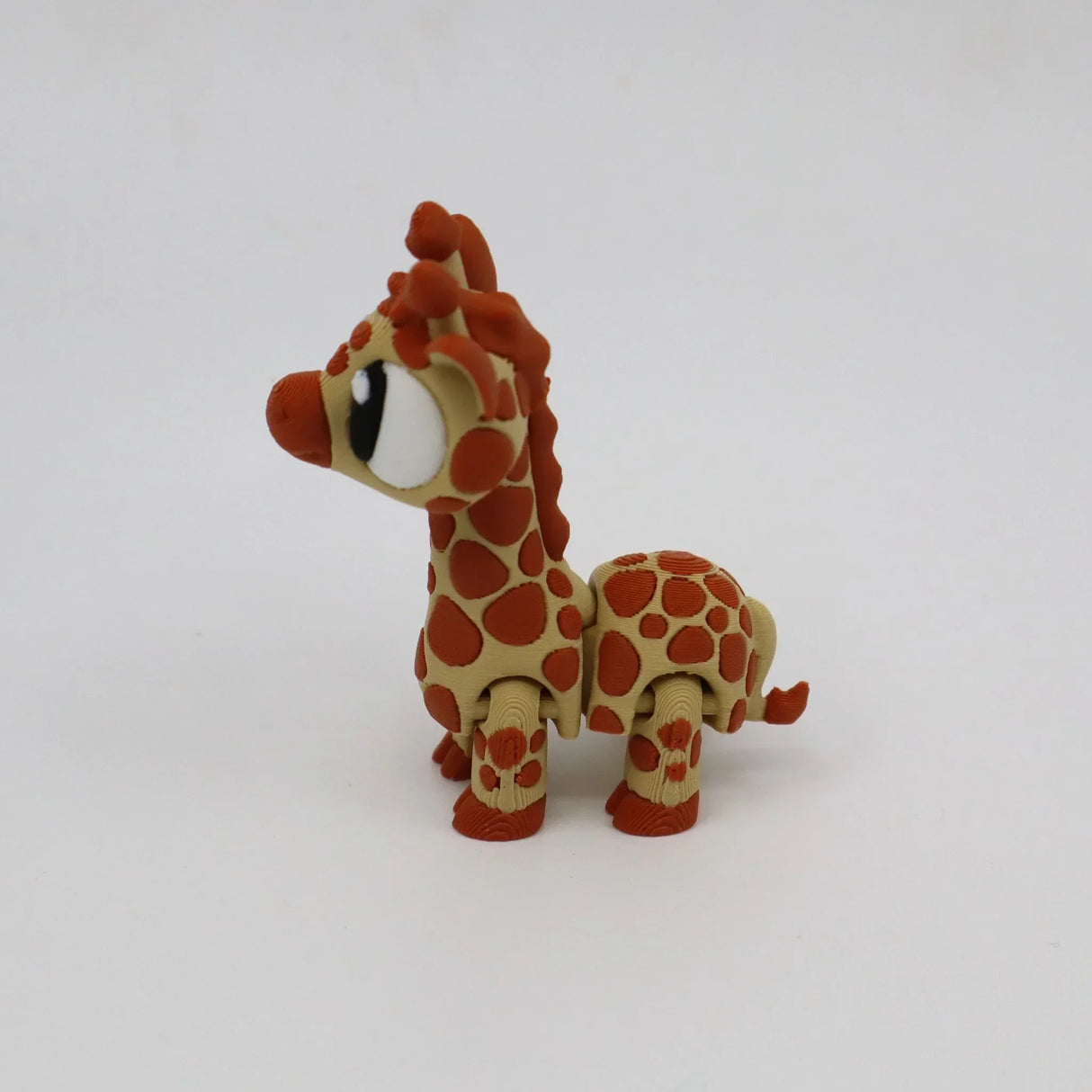 3D printed sensory giraffe toy with orange spots on a white background
