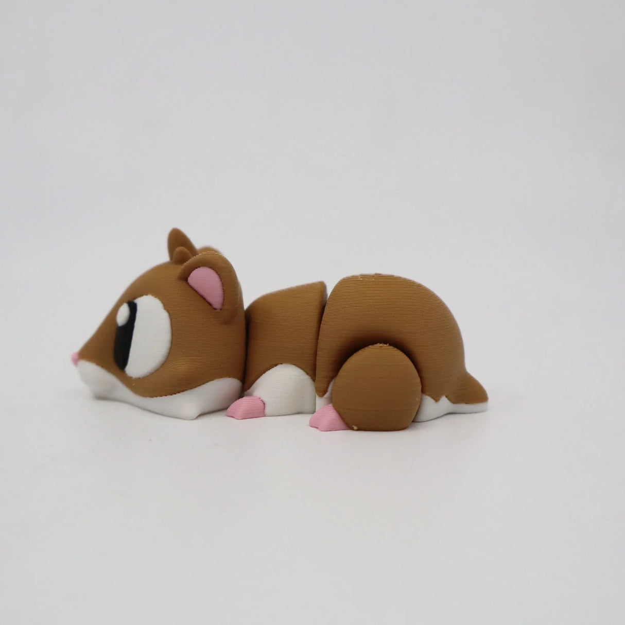 3D printed brown hamster sensory toy with white and pink accents on a plain background